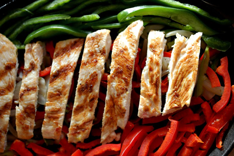 Sizzling beef fajitas served on a cast iron skillet